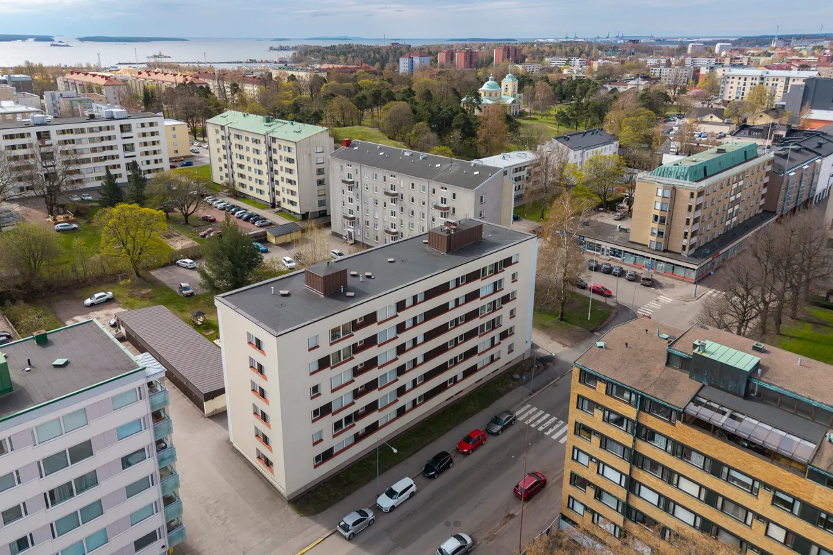Aerial view of an apartment block area in Kotka with the sea and green areas behind