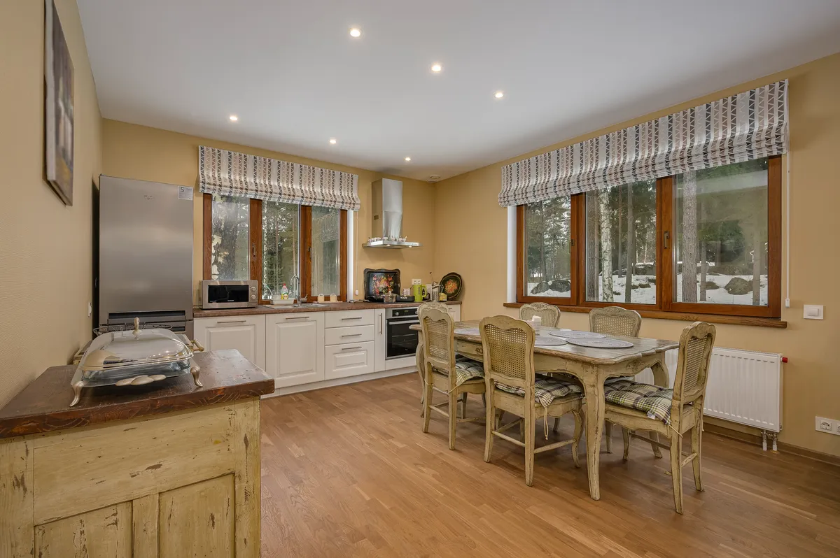 Bright kitchen and dining area with two large windows
