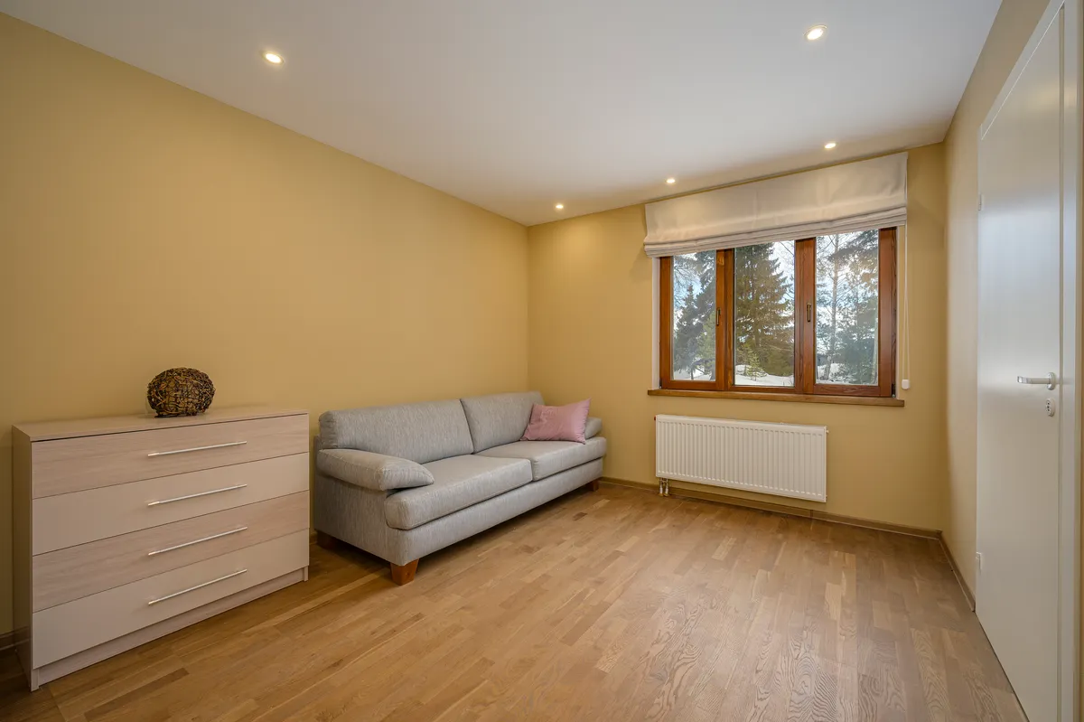 Bright living room with a light sofa and a large window